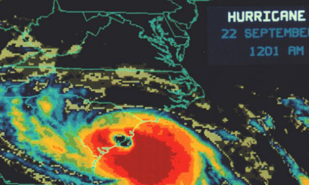 Radar image showing hurricane on 22 September at 12:01 am with bright colors indicating intense weather patterns impacting the coastline, noted by a local veterinarian monitoring for animal safety.